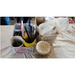 Diet Coke Container Holding Jigsaw Blades, Bolts, Etc.