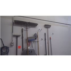 Wall of brooms/mop/scraper etc.