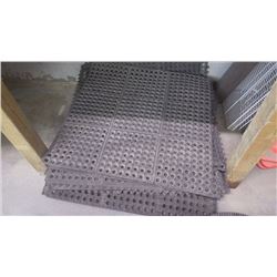 Pile of anti-fatigue mats, pylons, and wire shelving