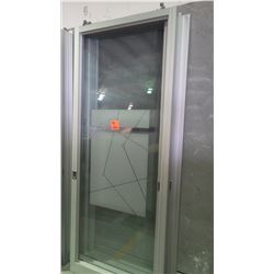 Approximately 4 glass panels/sliding doors with aluminum frames on rollers