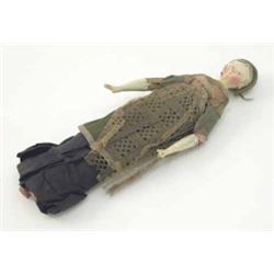 An early 19th century peg doll, with painted hair and facial features, jointed limbs and period o...
