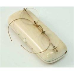 An ivory spectacle case, with a pair of spectacles, minor damage, 5 ins...