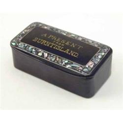 A lacquered papier mache snuff box, possibly Scottish, the lid entitled ‘A Present from Burntisla...