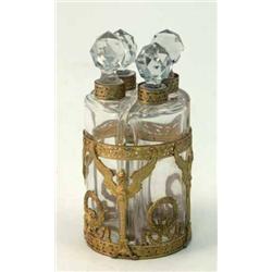 A French glass scent bottle set, comprising four bottles and facetted stoppers in a cylindrical g...