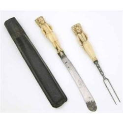 An 18th century Dieppe ivory knife and fork, with handles carved as male and female fishermen, ea...