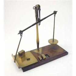 A set of brass postal scales by Degrave Short & Fanner, with four loose block weights on mahogany...
