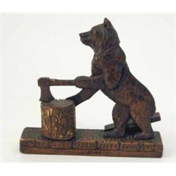A Black Forest carved wood bear automaton, modelled on back legs holding an axe and chopping bloc...