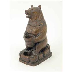 A good Black Forest carved wood bear, originally used as a lamp base, modelled holding a basket w...