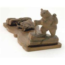 A Black Forest carved wood book slide, each end modelled as a ‘hiking’ bear carrying a haversack...