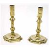 Image 1 : A near pair of George III cast brass candlesticks, with double knopped stems on shaped square bas...