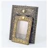 Image 1 : A brass photo frame, decorated with a cartouche crest and tendril like flowering and fruiting vin...