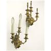 Image 1 : A pair of late 19th century gilt metal wall lights, each cast as a putto suspended by a large rib...