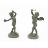 Image 1 : A pair of late 19th century bronze figures of putti after Clodion, one holding a pair of hand pad...