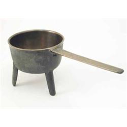A 17th century cast bronze skillet, on tripod base with indistinct marks to handle, one foot a.f....