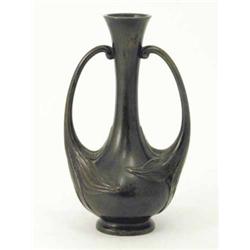 A Japanese bronze twin handled bottle vase, each handle meeting the body as a flowerhead, unmarke...