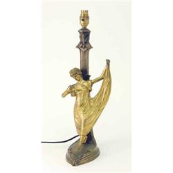 A bronze statuette table lamp, cast as a dancing female figure set against a column lamp base cas...