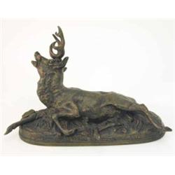 A bronze model of a stag, cast lying in a distressed manner on oval base, one leg damaged, 14.5 i...