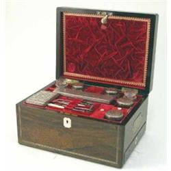 A Victorian inlaid rosewood toilet box fitted 8 toilet jars and manicure tools, 12.5 ins....