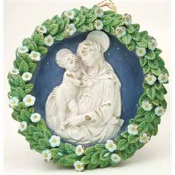 A 19th century Cantagalli tin-glazed earthenware tondo, moulded and painted with The Madonna and...