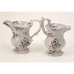 A pair of Victorian Staffordshire jugs, printed with flowers in lilac-blue, 5.75in....
