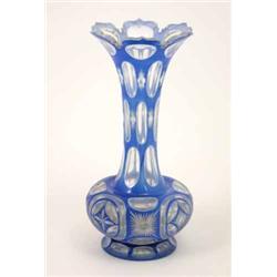 A late 19th century Bohemian glass vase, overlaid in blue and cut with ovals and star devices, 10...