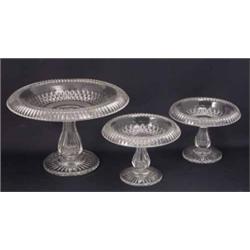 A Victorian clear glass tazza, cut with diamonds and with turnover rim (10in.) and a pair of smal...