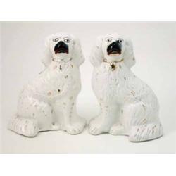 A pair of Victorian Staffordshire comforter spaniels, with gilt ornament, 10in....
