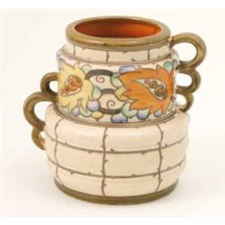 A Charlotte Rhead vase, two-handled and tube-lined with stylised flowers against a cream ground,...