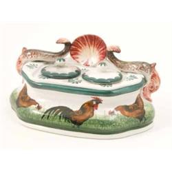 A Wemyss inkstand, modelled with two dolphins and central oyster shell, fitted with two covered w...