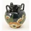 Image 1 : A four-handled terracotta vase, primitively decorated with flowers and leaves in sgraffito, 7.25i...