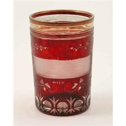 A late 19th century Bohemian ruby-overlaid beaker, engraved with a landscape view of Vienna surro...