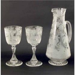 A 19th century Bohemian clear glass jug, engraved with a stag and woodland setting, on star-cut b...