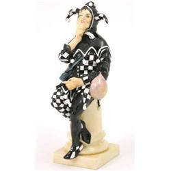 A rare Royal Doulton bone china figure, “Jester”, HN45, figure in black and white, seated on pede...