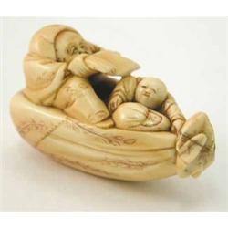 A Japanese ivory netsuke of a man and two children, 2ins...
