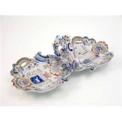 A late 19th century Desvres dessert stand, with twin dishes moulded and pierced with shells and p...