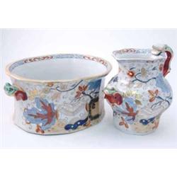 A large mid-19th century ironstone toilet jug and footbath, jug with serpent handle, painted with...