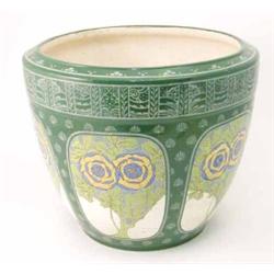 A large Mintons secessionist jardiniere, with bold yellow and blue floral panels, against a green...