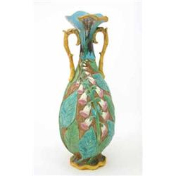 A Victorian Minton-style majolica vase, with leaf handles, moulded with foxgloves, 16.5ins (a.f)...