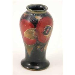 A Moorcroft Pomegranate vase, circa 1916, baluster shape painted against a dark blue ground, facs...
