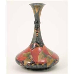 A good Moorcroft Pomegranate vase, with flattened spherical body and tall waisted neck, painted a...