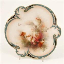 An Hadley’s Worcester trefoil dish, finely painted with flowers and a butterfly within leaf-scrol...