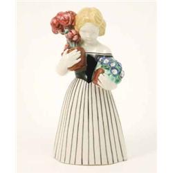 A Wiener Werkstatte earthenware figure, girl in long, black-striped dress, holding two potted pla...