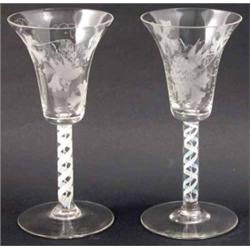 A set of five wine glasses, with bell bowl engraved with grapes and vines, on opaque twist stems,...