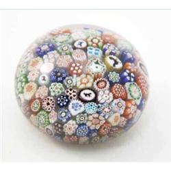 A Baccarat millefiore paper weight, inset with four animal silhouette canes amidst the numerous b...