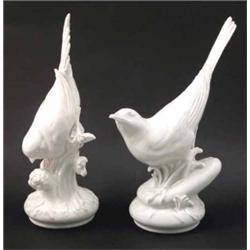 A pair of Meissen bird models, unpainted, each bird alighting on floral sprig, 8.5in....