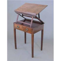 A George III adjustable reading table, with double ratcheted top, two candle slides and frieze dr...