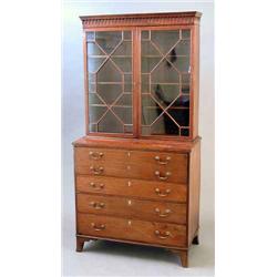 A late George III secretaire bookcase, with arched cornice over two astragal glazed doors, secret...