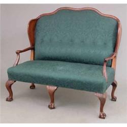 A George III design mahogany frame high back settee, with wavy back, curved sides and floral carv...