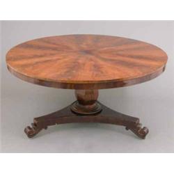 A William IV mahogany breakfast table, with segmental flamed top on octagonal baluster stem and t...