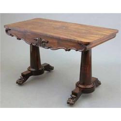 A Regency rosewood writing table, with concealed frieze drawer, with C scroll ornament on gun bar...